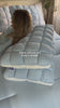 Blue quilted puff pillow on a made bed
