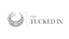 The Tucked In logo