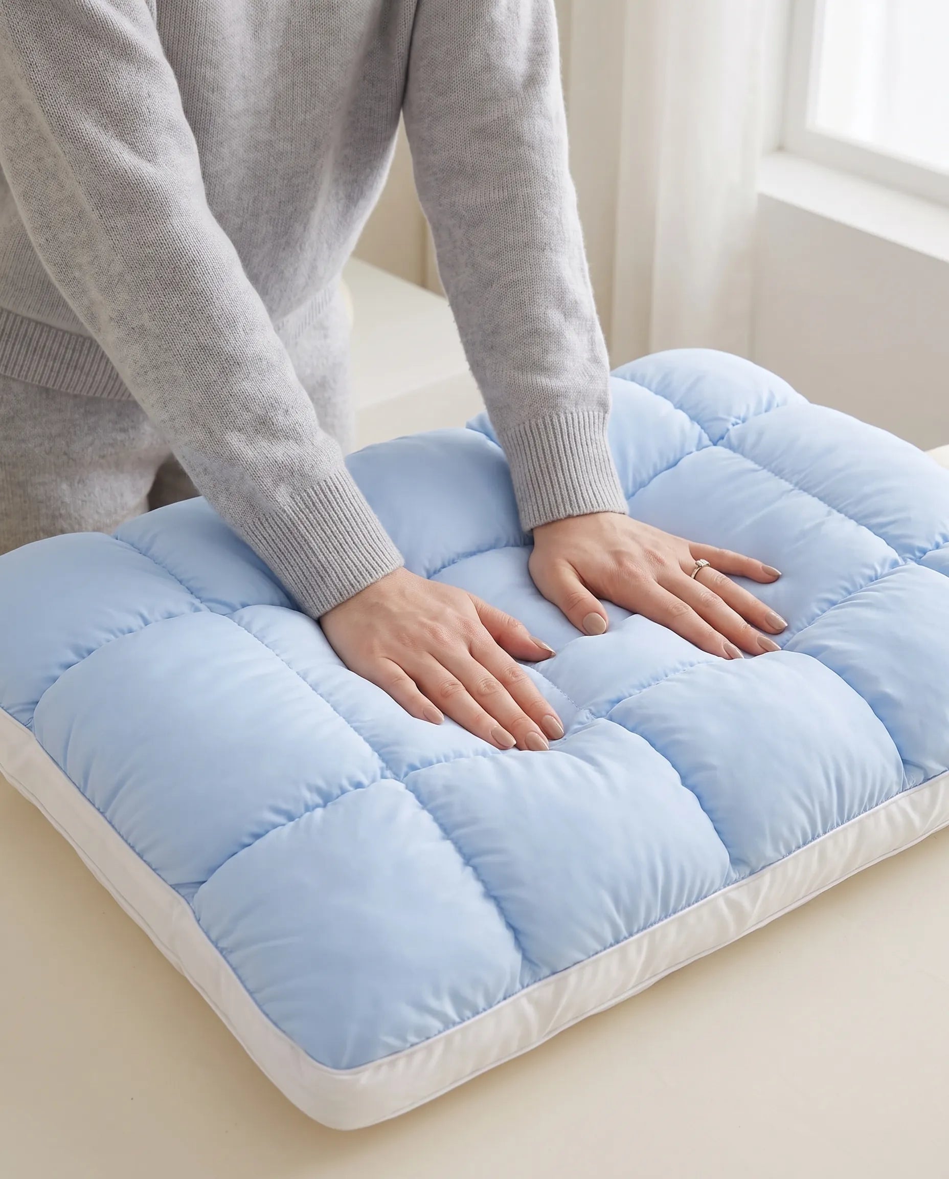 Hand sinking into the soft pillow